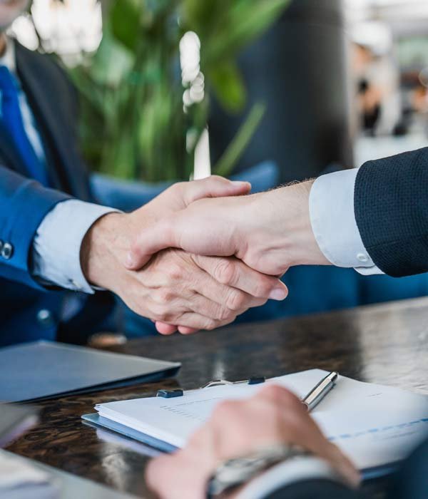 Two business people shaking hands, representing a partnership in Surety Bonds in Grand Junction, CO
