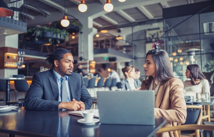 Two colleagues are discussing details related to restaurant insurance in Grand Junction, CO