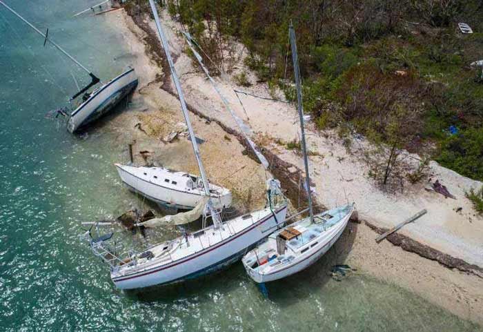 Three boats resting on the sandy beach, showcasing a peaceful coastal scene in Grand Junction, CO
